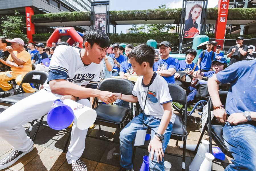 王維中連續三年擔任MLB棒球樂園活動大使，看到同樣連續三年參與的罕病病童吳兆峰開心握手。(大漢集團提供)