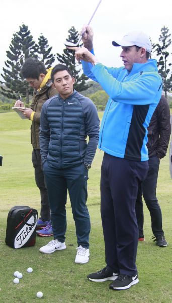 潘政琮（左）的澳洲籍揮桿教練Tony（右）正在對學員們講解切桿角度。