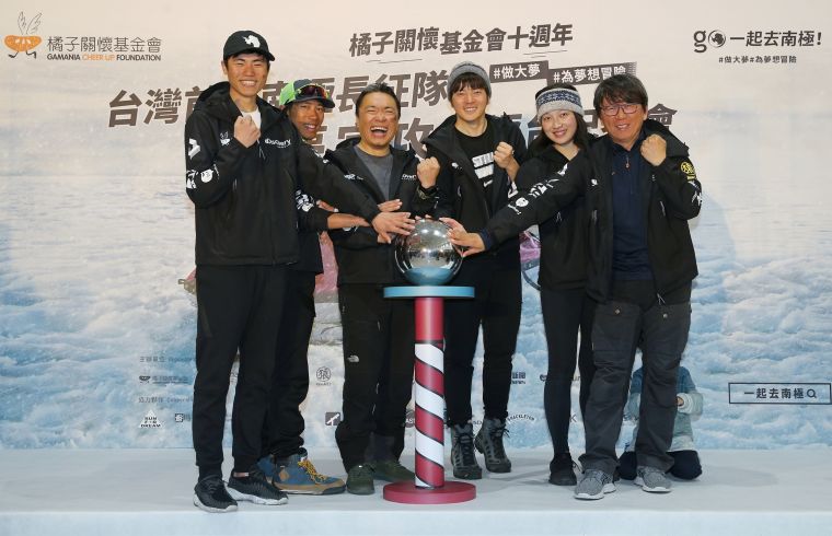 五位南極長征隊員與楊力州導演在道具南極地標前開心留影。