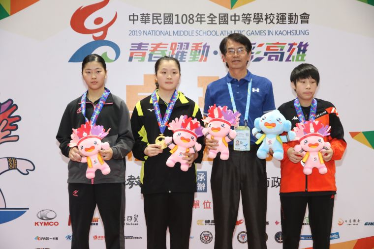 高雄市桌球委員會主委黃鐘龍（右2）頒發國女組朱以晴（左2）、陳采妮（左1）、蔡昀恩婷前三名獎牌後合影。全中運大會提供